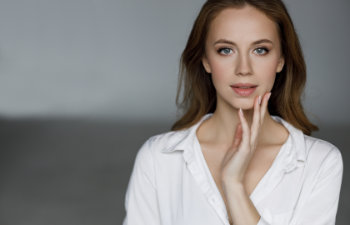 blonde haired woman in a white shirt and soft make up, 