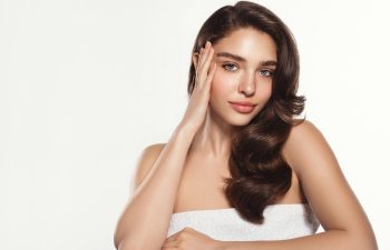 Studio, shine and portrait of woman, touch and treatment of skincare, soft and glow of body in results. White background, face of radiant female model, concept for skin, dermatology and cosmetics., 